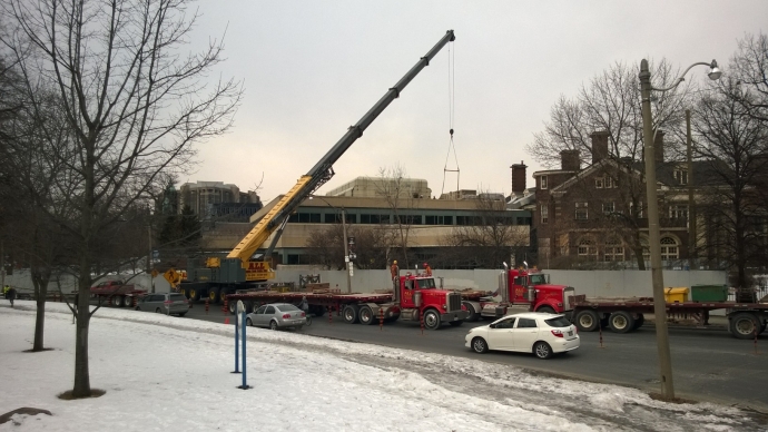 Crane removing the rooftop heating unit from library rooftop.